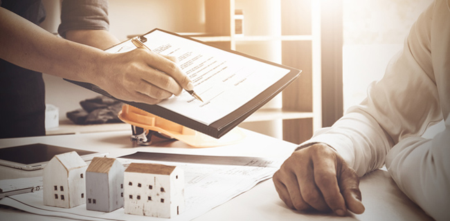 close up of business man pointing and signing agreement for buyi